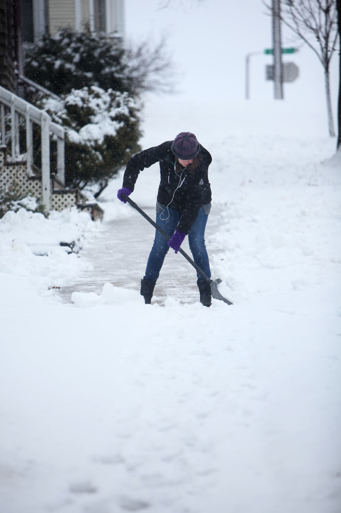 Student clears sidewalk after January 2017 storm